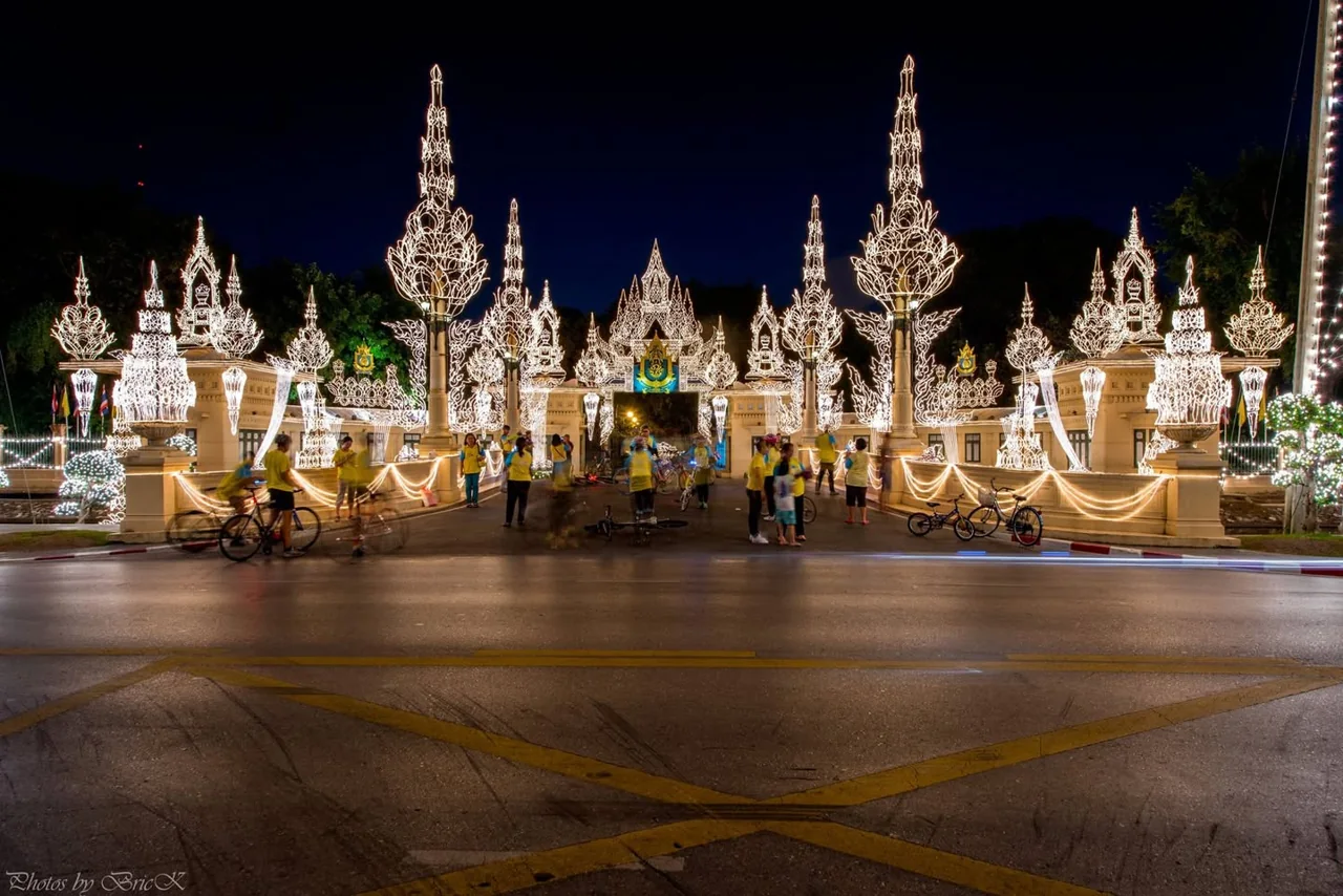 An ornate illuminated building with pointed towers at night.