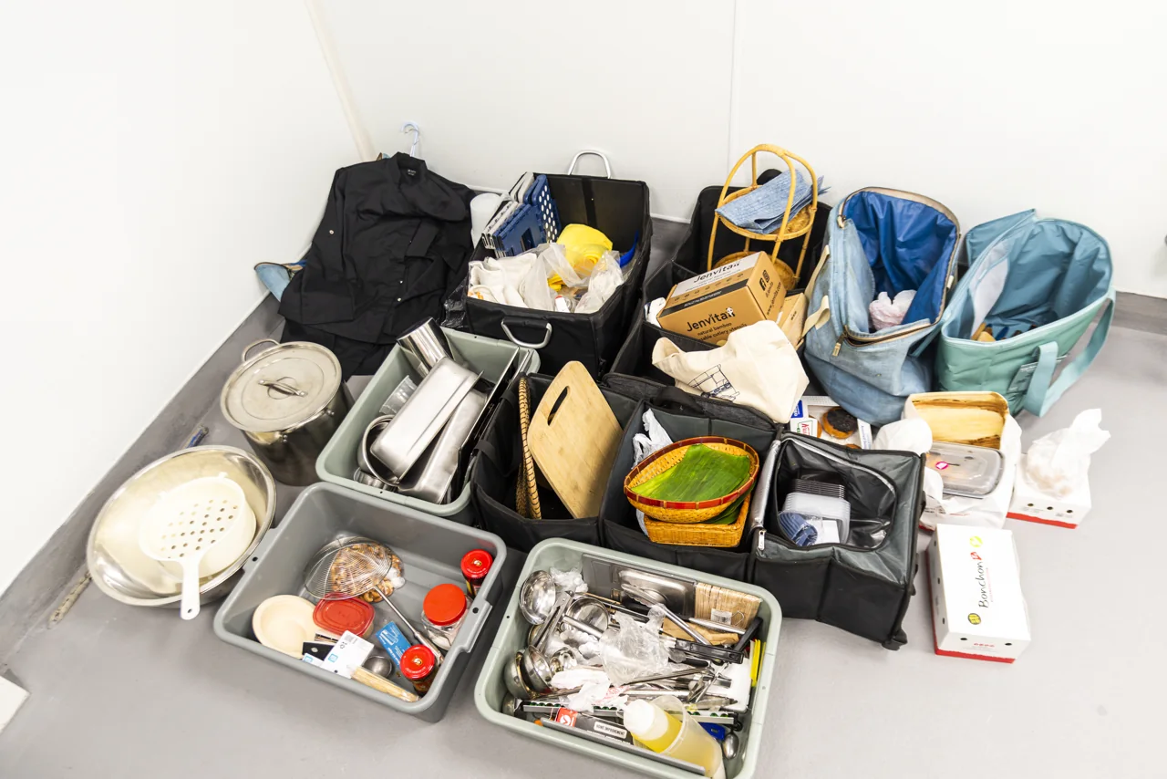 Prepared ingredients fill trays in an overhead kitchen view.